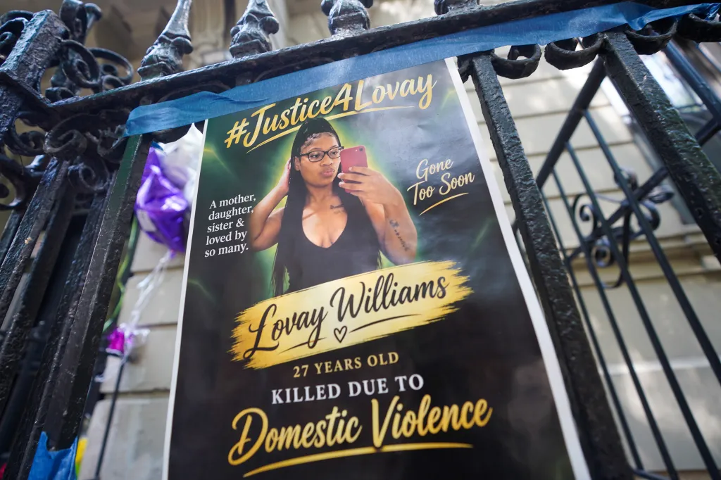 A memorial poster honoring Lovay Williams, 27, hangs outside her Washington Heights apartment building after her death on Sept. 6.