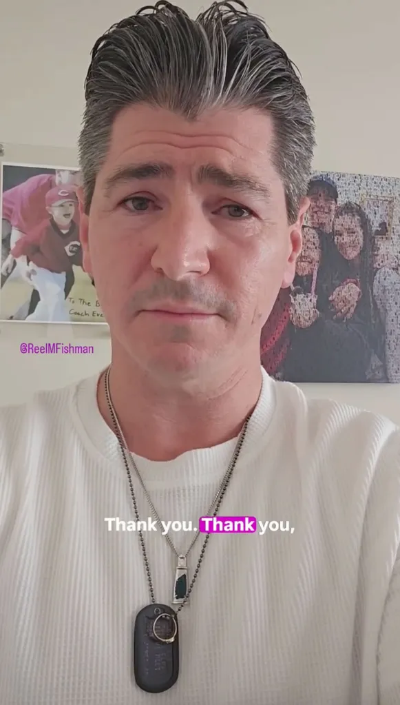 Michael Fishman wearing two necklaces, with 