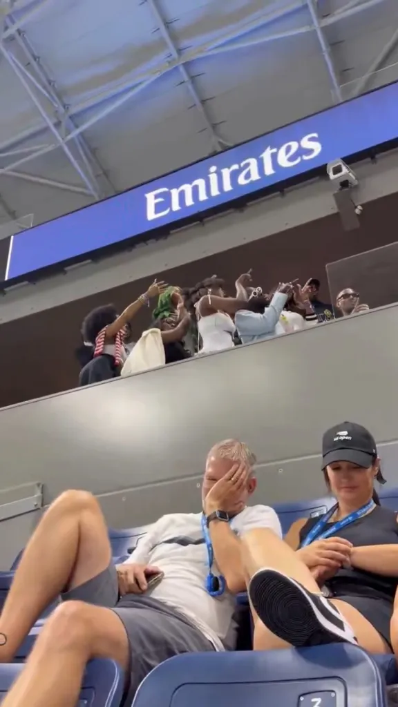 Spectators react to influencers doing a photoshoot at the US Open.