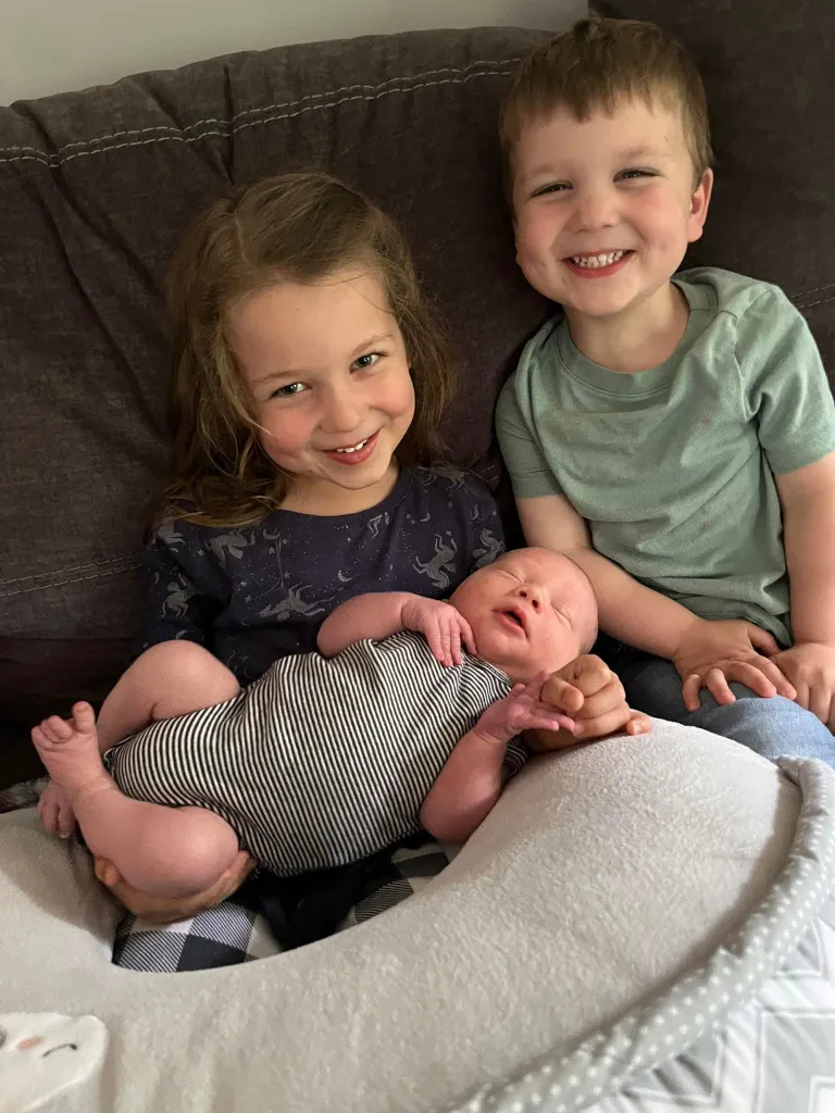 Siblings Cora, Dawson, and their baby brother, who died from strangulation.