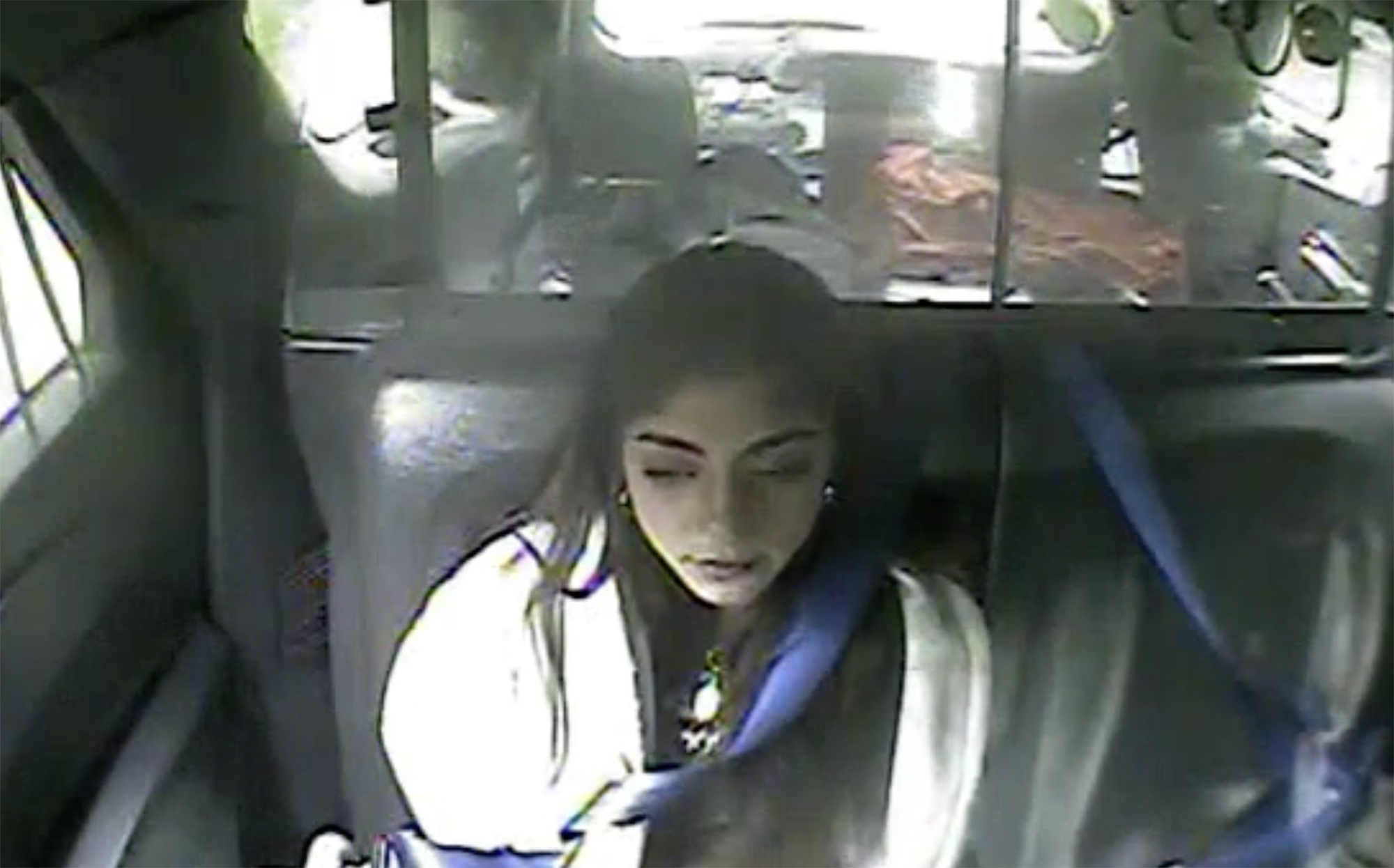 Milania Giudice in the back of a vehicle, viewed from a bodycam.