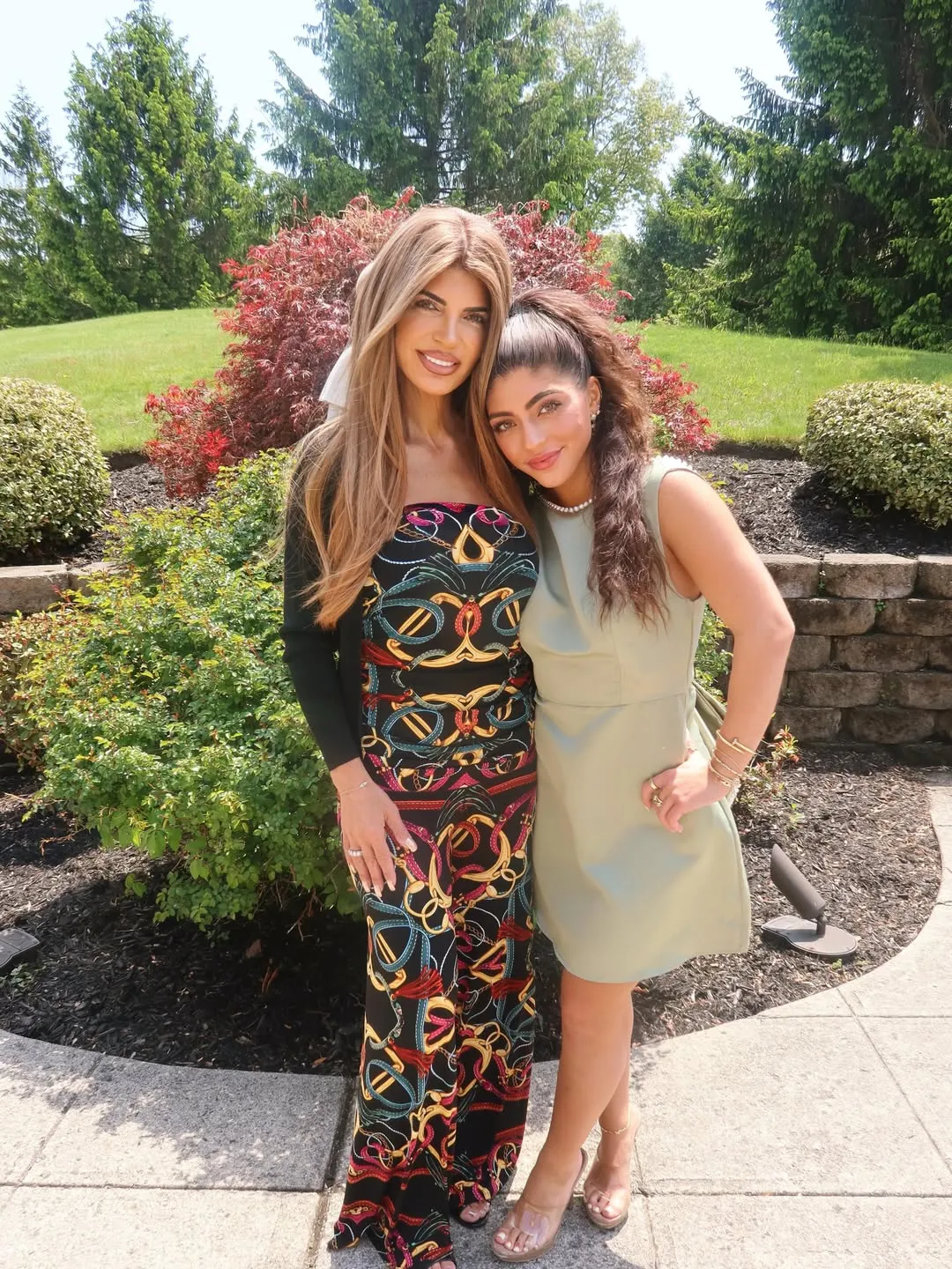 Milania Giudice and Teresa posing together outdoors.