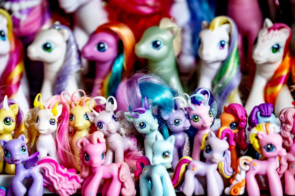 A large collection of colorful My Little Pony toys, featuring various pony designs and hair colors.