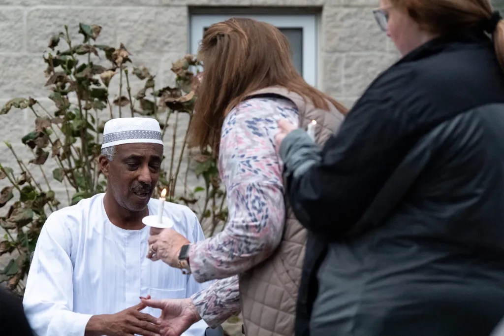 Mohammed Osman receives condolences during a vigil for his son.