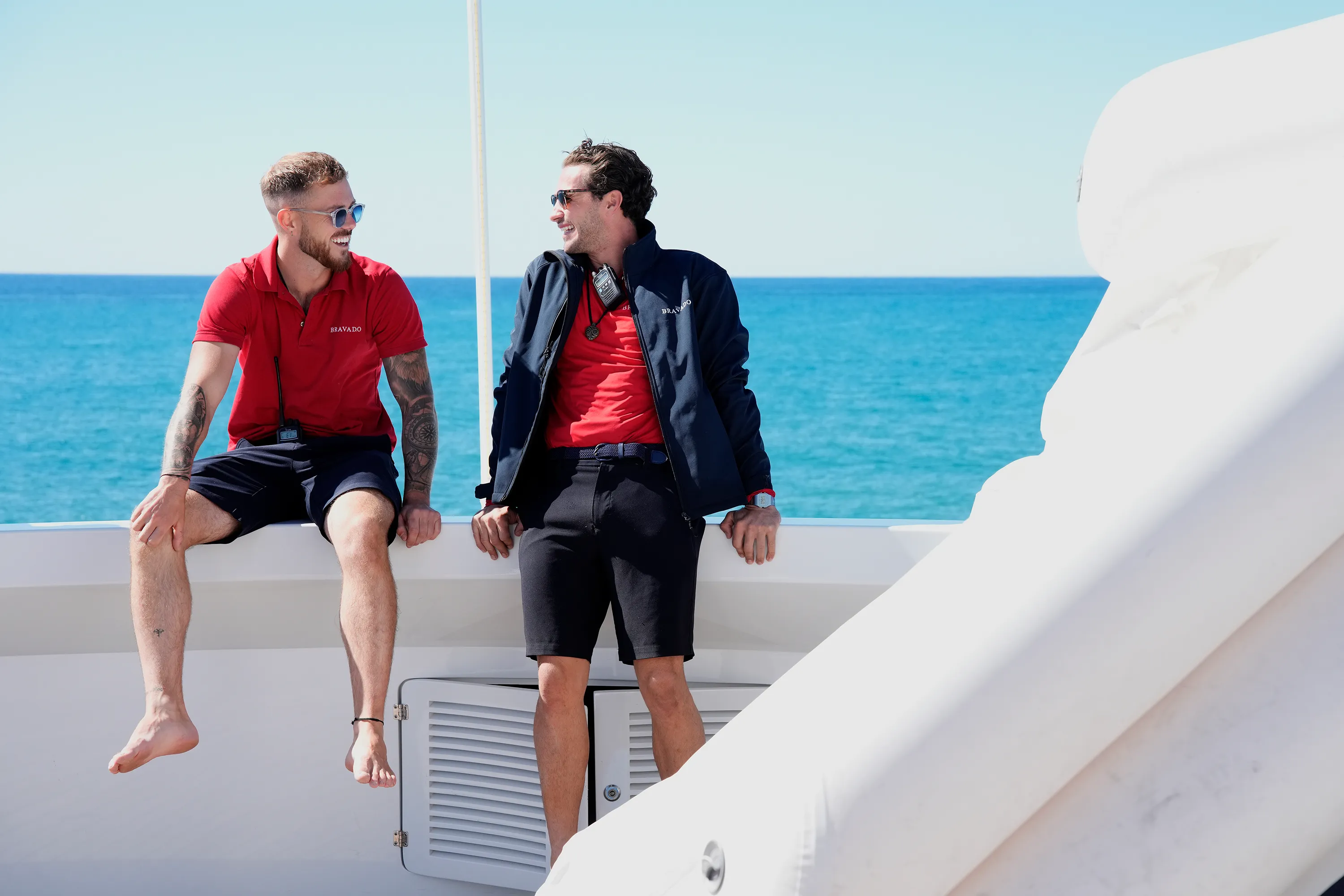Nathan Gallagher and Joe Bradley on a boat with the ocean in the background.
