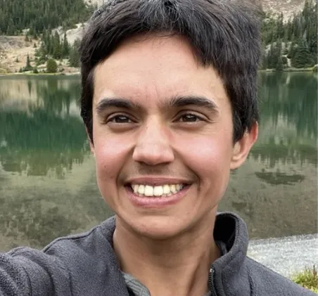 Portrait of missing hiker Neil Gehring smiling in front of a lake and mountains.