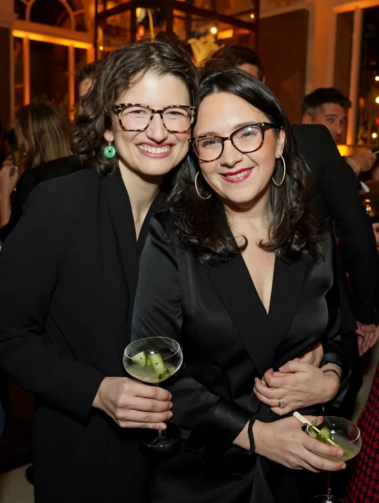 Nellie Bowles and Bari Weiss smiling and posing with drinks at an event.