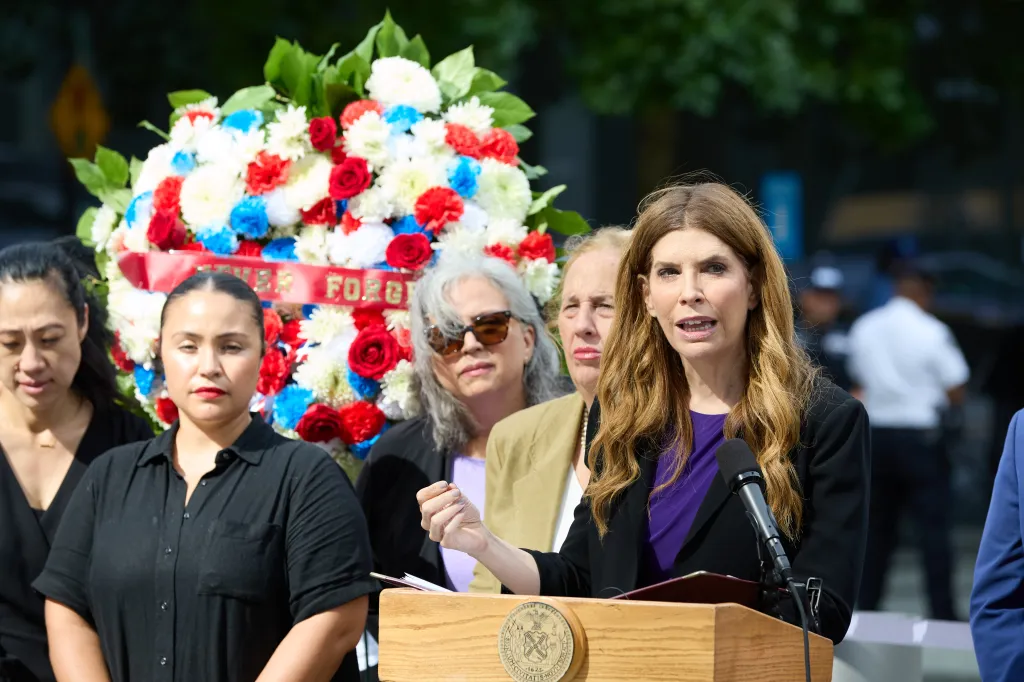 New York City Council Speaker Julie Menin speaks at a podium about 9/11 educational programming.