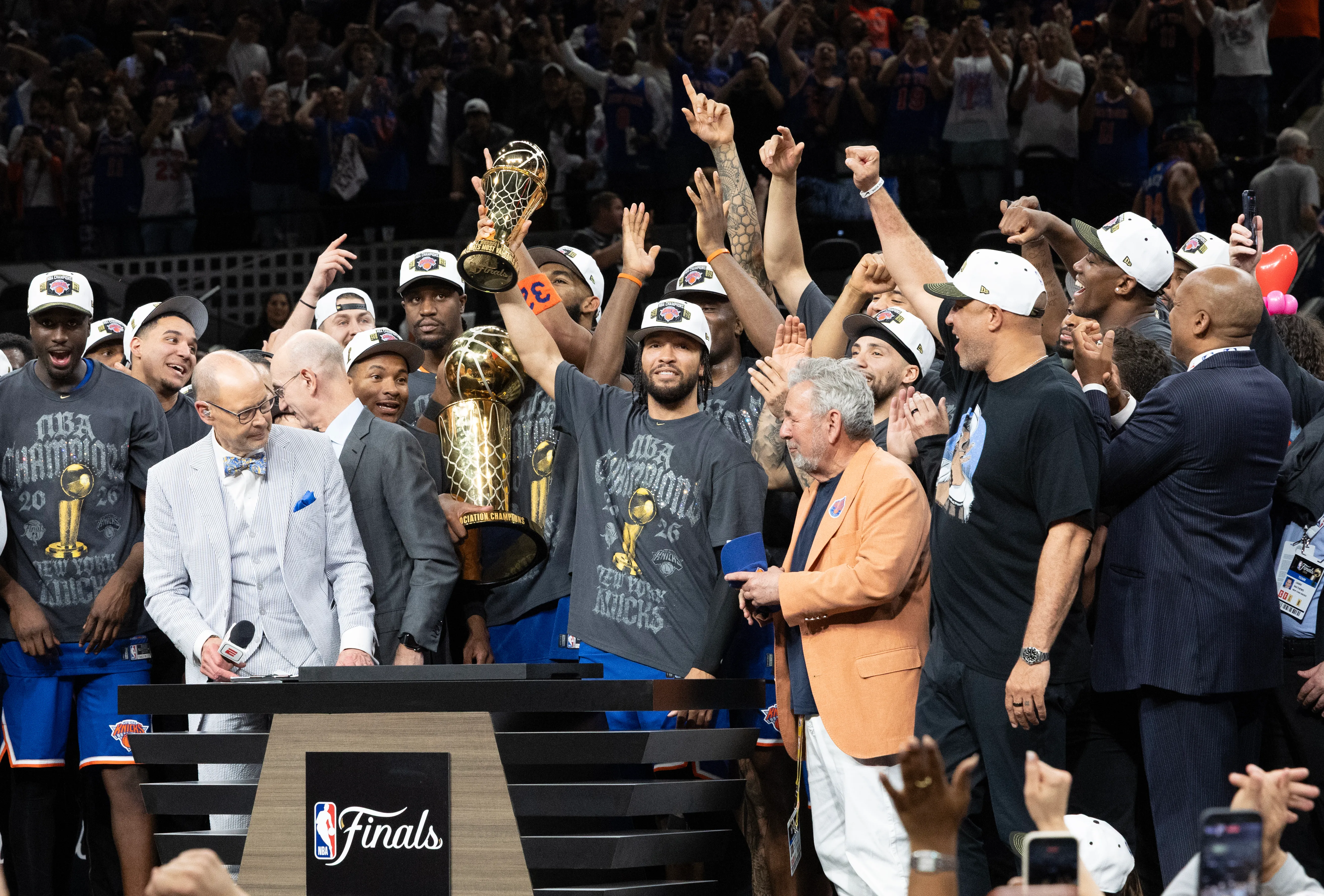 New York Knicks guard Jalen Brunson holds up the MVP trophy after winning the NBA championship against the San Antonio Spurs.