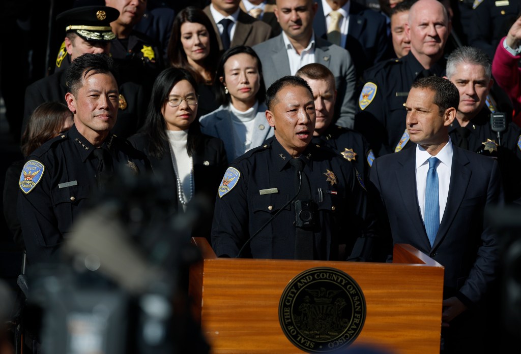 San Francisco Police Chief Derrick Lew speaks at a news conference next to Mayor Daniel Lurie.