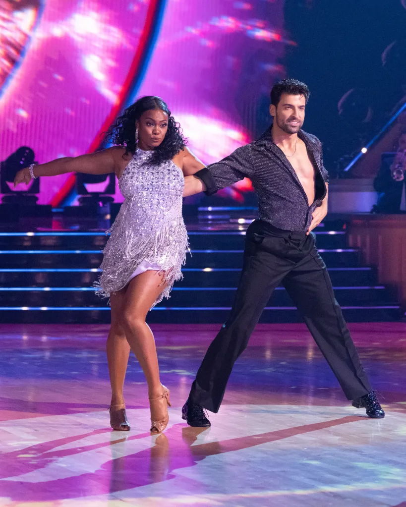 Tatyana Ali and Jan Ravnik dancing on stage.
