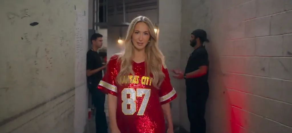 Nikki Glaser in a sparkly red Chiefs jersey with 