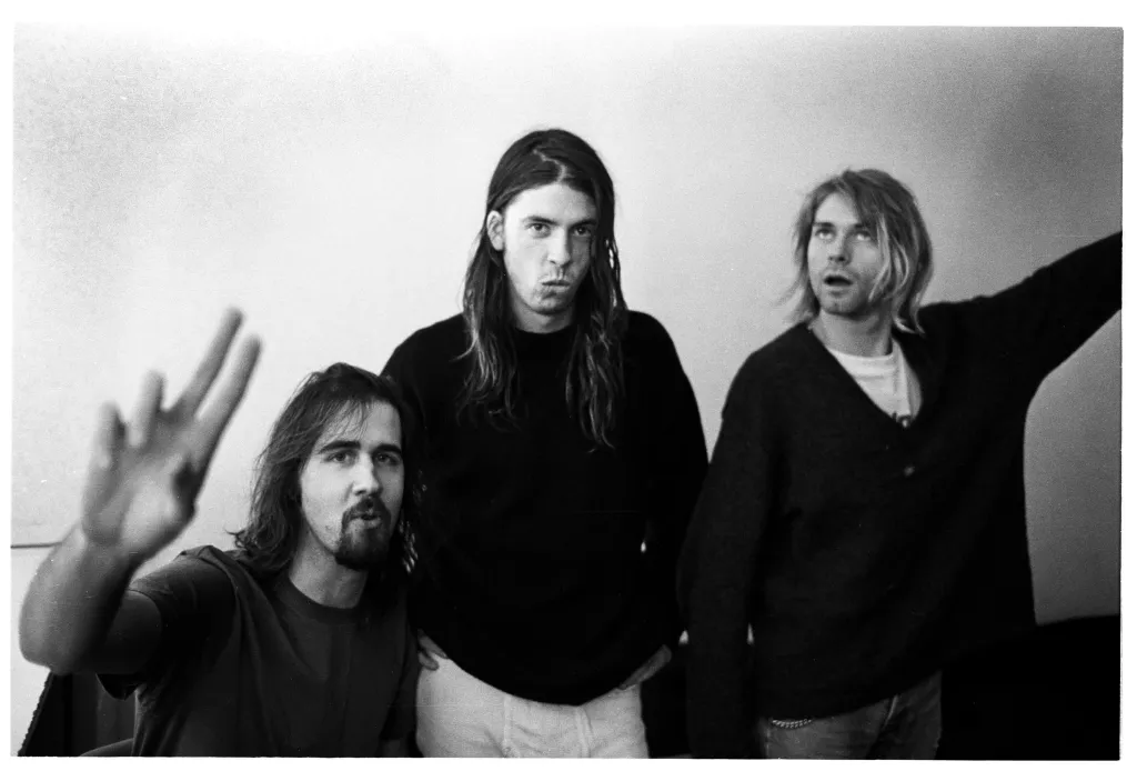 Black and white photo of Nirvana band members Krist Novoselic, Dave Grohl, and Kurt Cobain.