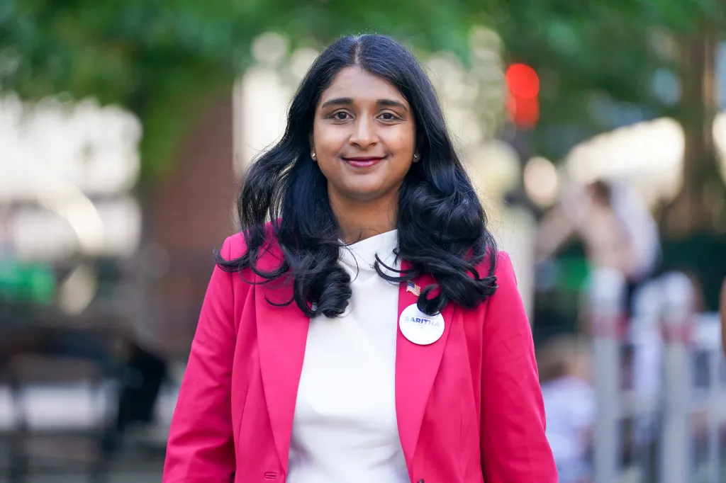 New York Attorney General candidate Saritha Komatireddy smiling and wearing a hot pink blazer.