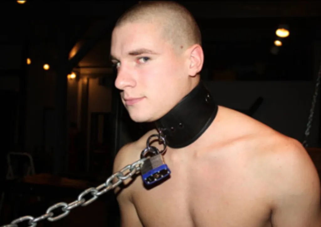 Christopher Gallant wearing a leather collar with a chain and padlock.