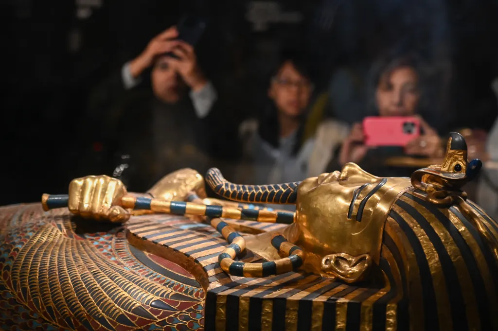 Visitors photograph the sarcophagus of King Tutankhamun inside the Grand Egyptian Museum.