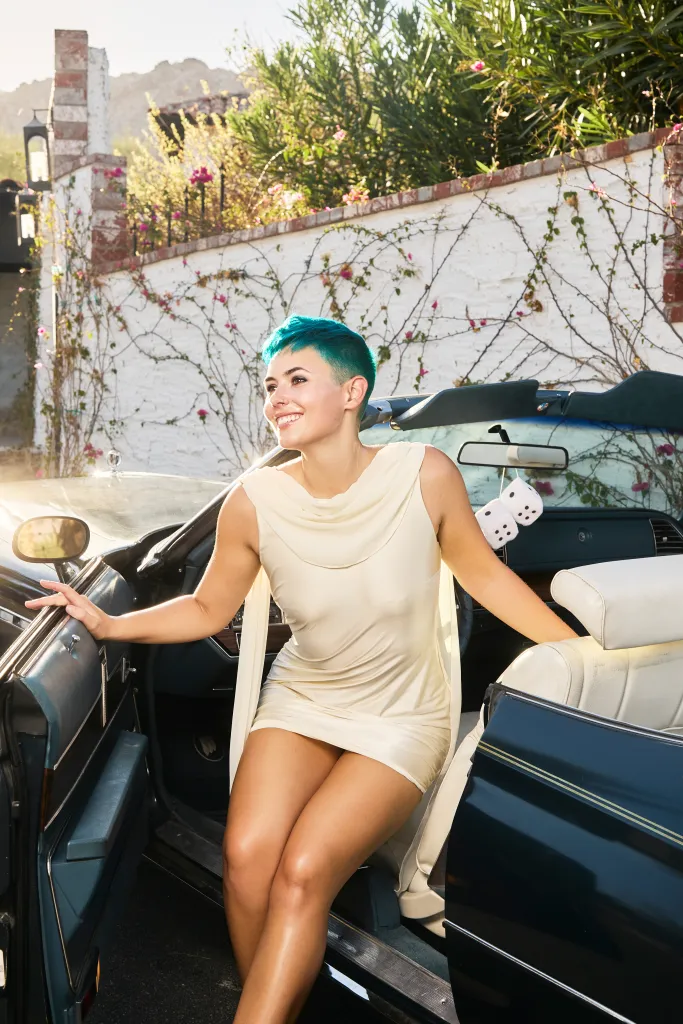 OnlyFans creator Kit Barrus with blue hair getting out of a car