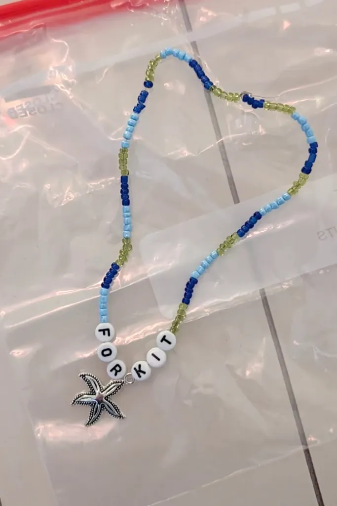 A beaded bracelet that says Kit Burrus