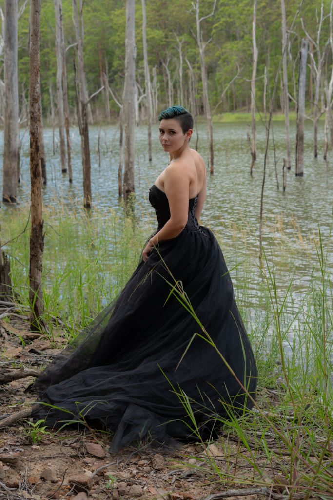 OnlyFans creator Kit Barrus in a black gown by a lake
