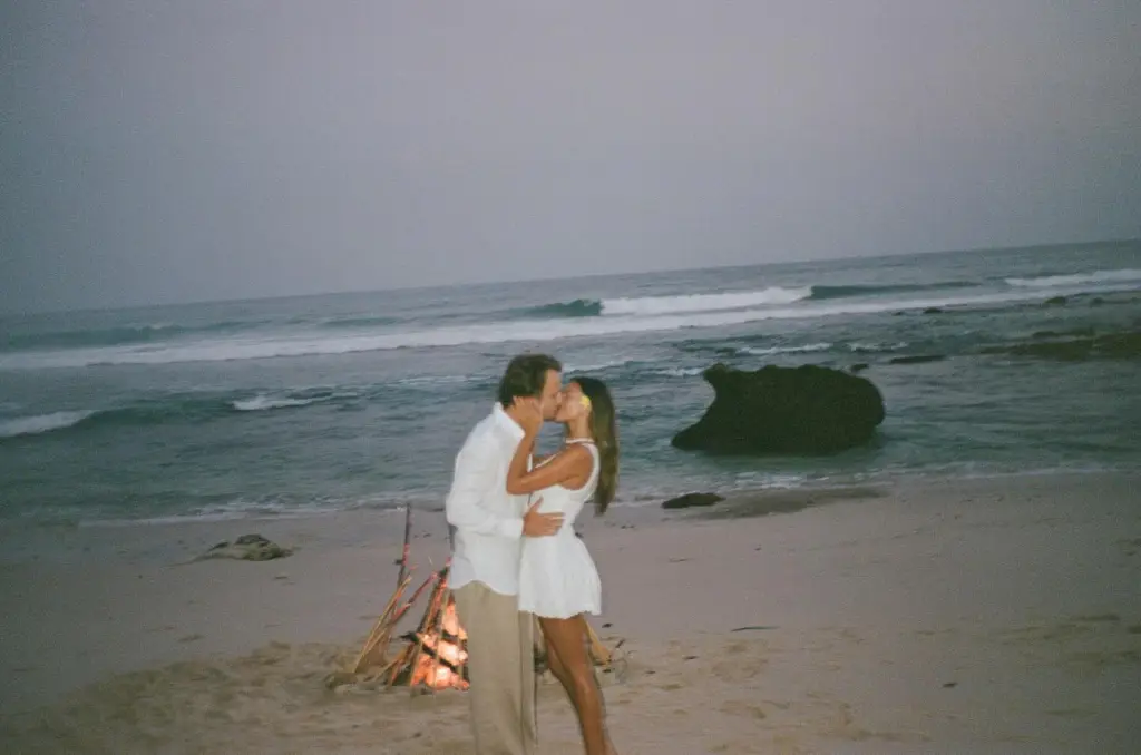 Brandon Lee and Katarina Demetriades kissing on a beach.