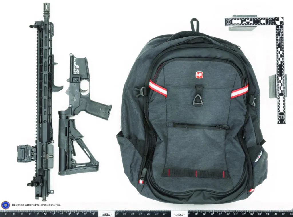 A Panther Arms semiautomatic rifle, broken down, next to a gray backpack and forensic rulers.