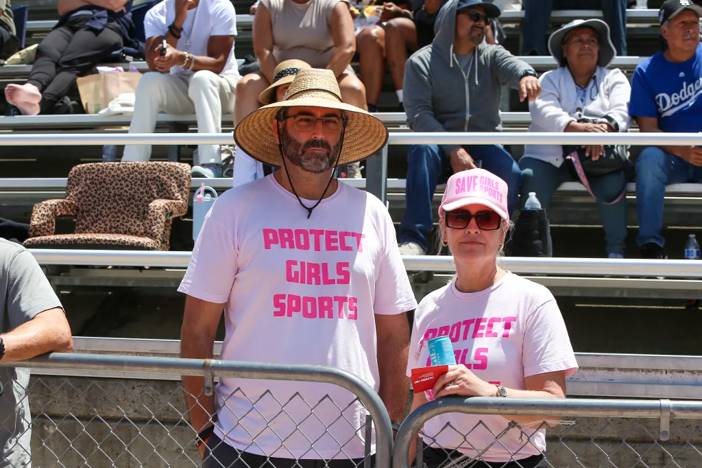 Tracy Howton and Juan Luis Viola cheer on their daughter, wearing 