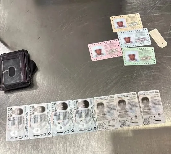 A wallet and several fake IDs discovered during a security screening.