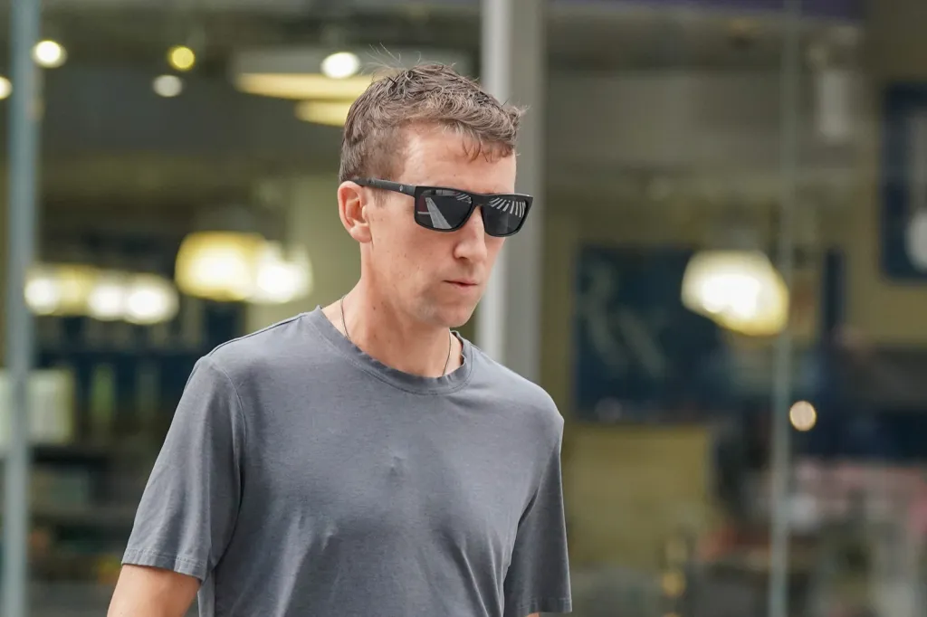 Patrick Clancy in sunglasses and a gray t-shirt.