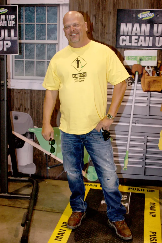 Reality TV star Rick Harrison posing at a Swiffer booth.