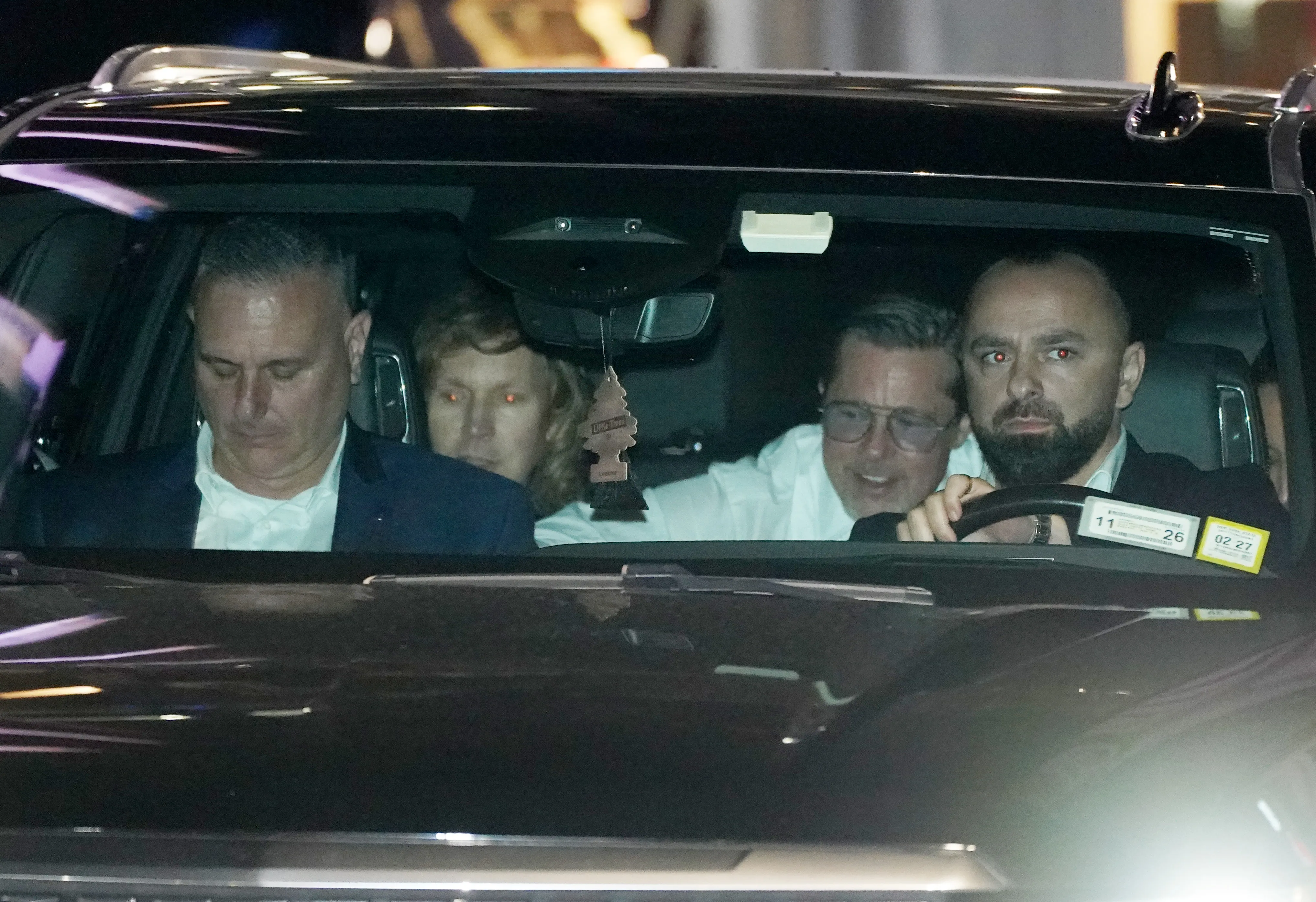 Beck, Brad Pitt, and other guests departing the wedding of Taylor Swift and Travis Kelce.