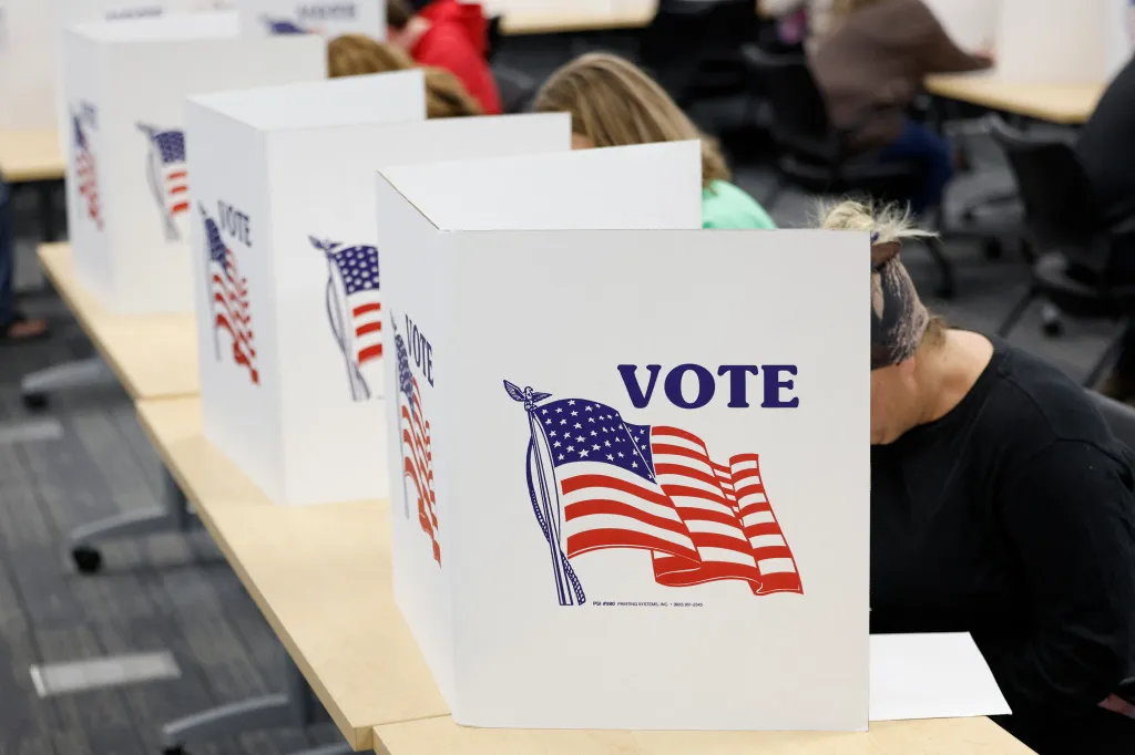 People casting ballots at individual voting booths on the last day of early voting.