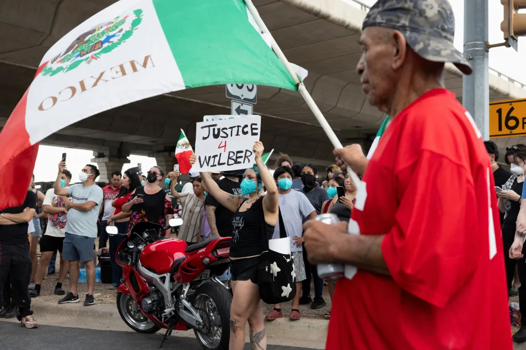 People protest near the site where a federal immigration officer shot and wounded a man in Austin, Texas, on Monday.