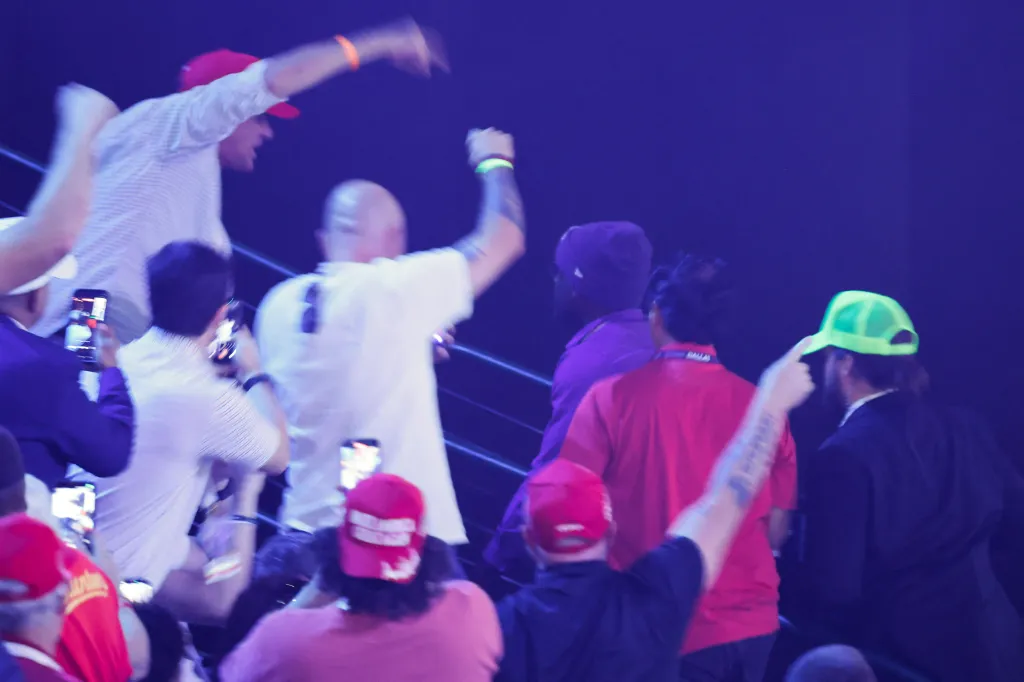 People reacting to a person waving a Mexican flag during a speech by JD Vance at the Republican National Midterm Convention.