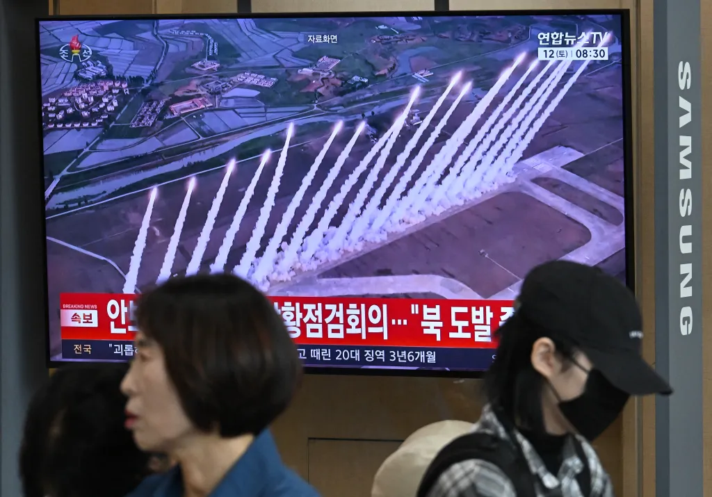 People watch a news broadcast showing a North Korean missile test at a Seoul train station.