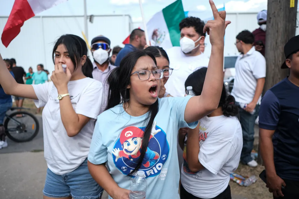 People speak during a demonstration on Sunday, in Austin, Texas, where a man was shot in his vehicle by an ICE officer.