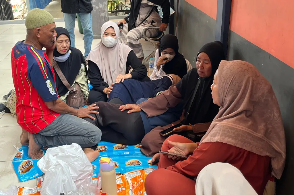 People wait for news on relatives after a ferry accident in Banjarmasin, South Kalimantan, Indonesia.
