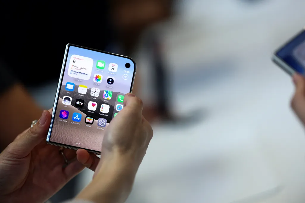 A person holding the new foldable iPhone Duo.