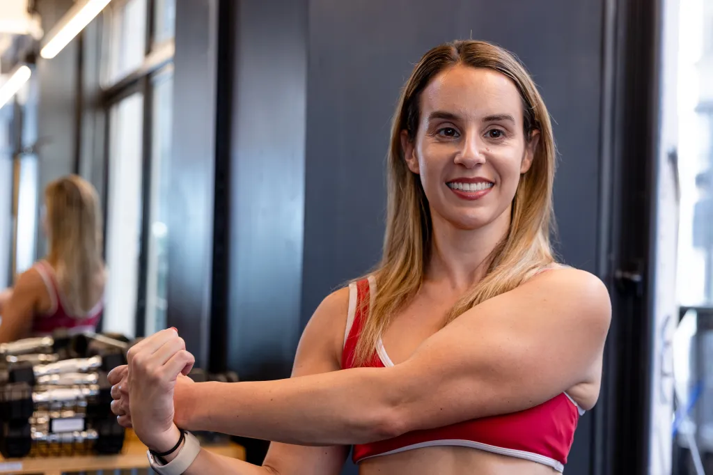 Personal trainer Sarah Cucuzzella of Aussie Fit NY poses to show muscle definition in her arms.