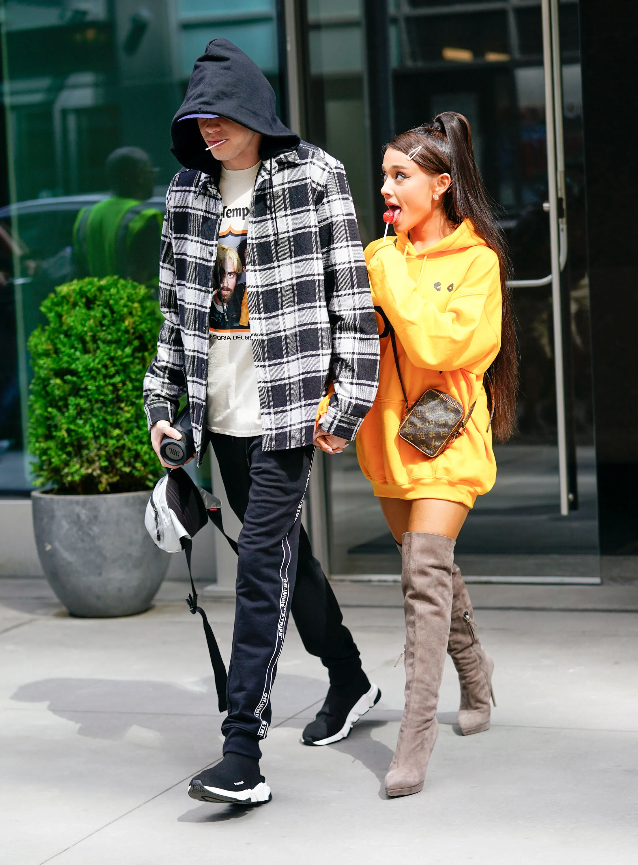 Pete Davidson and Ariana Grande holding hands while walking in New York City.