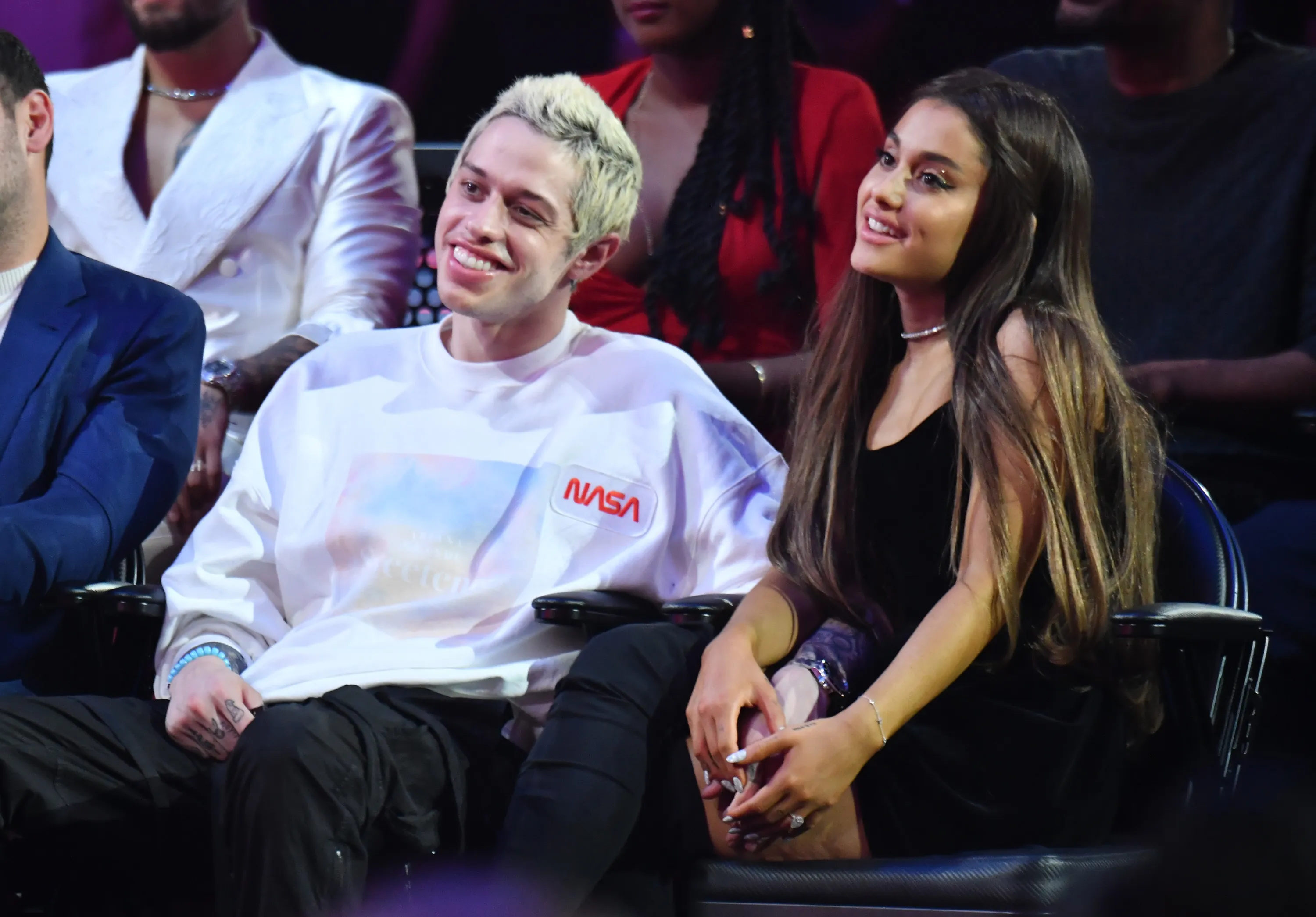 Pete Davidson and Ariana Grande sitting together at an awards ceremony.