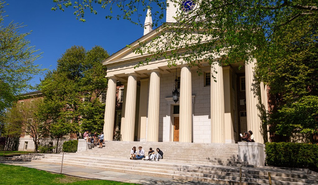 Phillips Academy, a large neoclassical building with a portico, on a sunny day.
