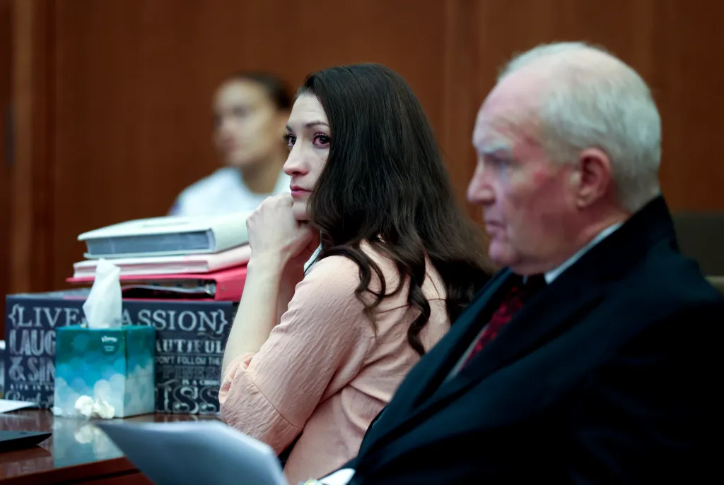 Lindsay Clancy and defense attorney Kevin Reddington listen to testimony at Plymouth Superior Court in Plymouth, Massachusetts, on Tuesday, August 18, 2026. A psychologist told jurors that Clancy said she heard a male voice ordering her to kill her children.