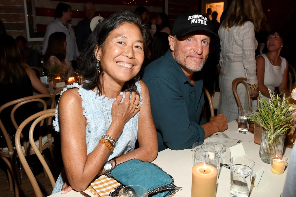 Laura Louie and Woody Harrelson seated at a table.