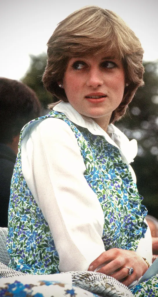 Diana, Princess of Wales, wearing a floral waistcoat over a white blouse, looking to her right.