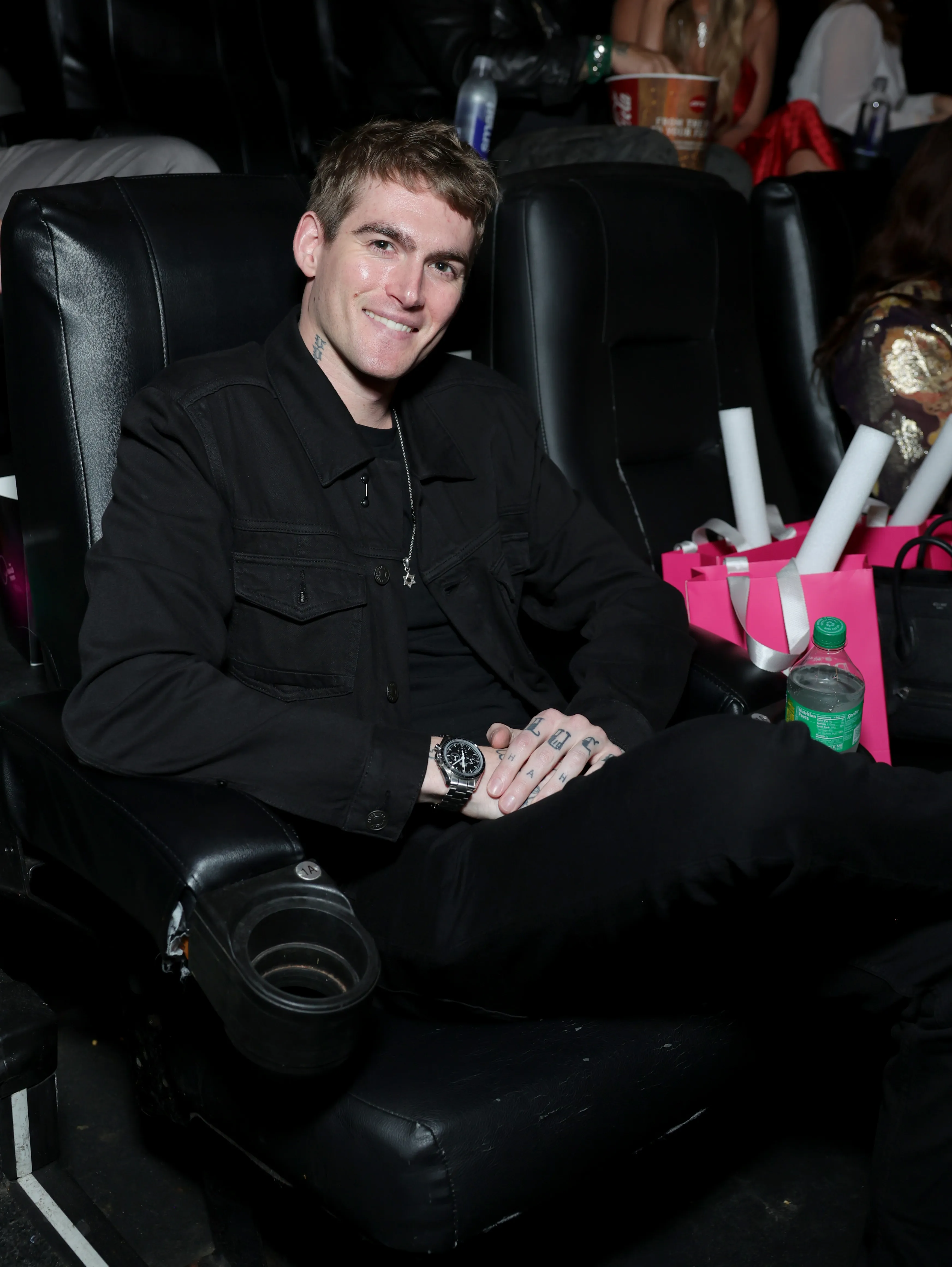 Presley Gerber seated and smiling at Paris Hilton's Infinite Icon: A Visual Memoir Los Angeles Premiere Event.