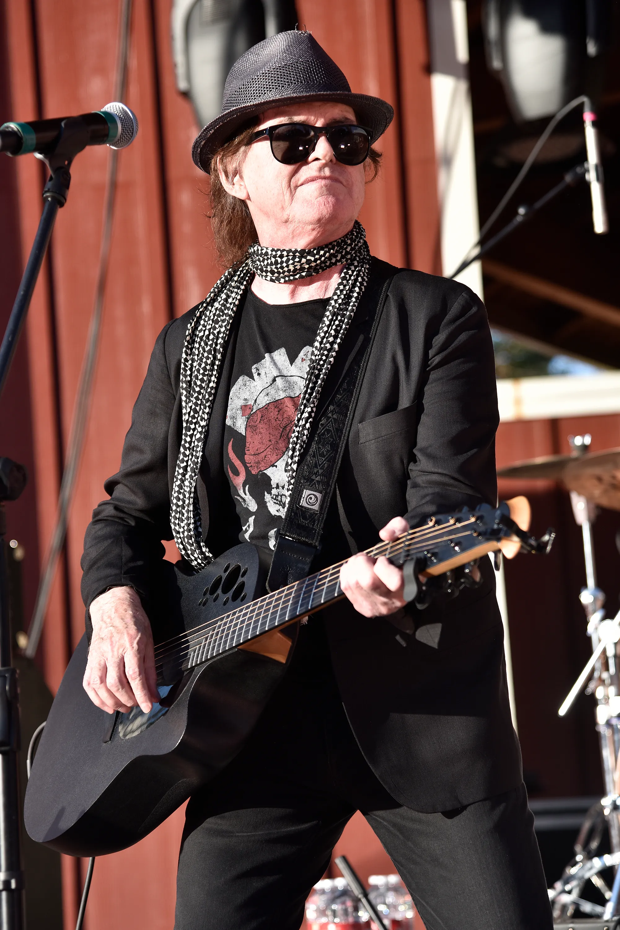 Pete Byrne of Naked Eyes performing with a guitar on stage.