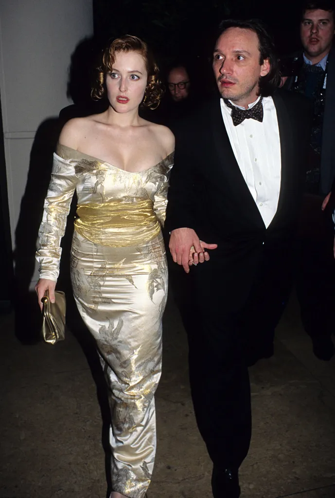 Gillian Anderson and Clyde Klotz walking together, holding hands.