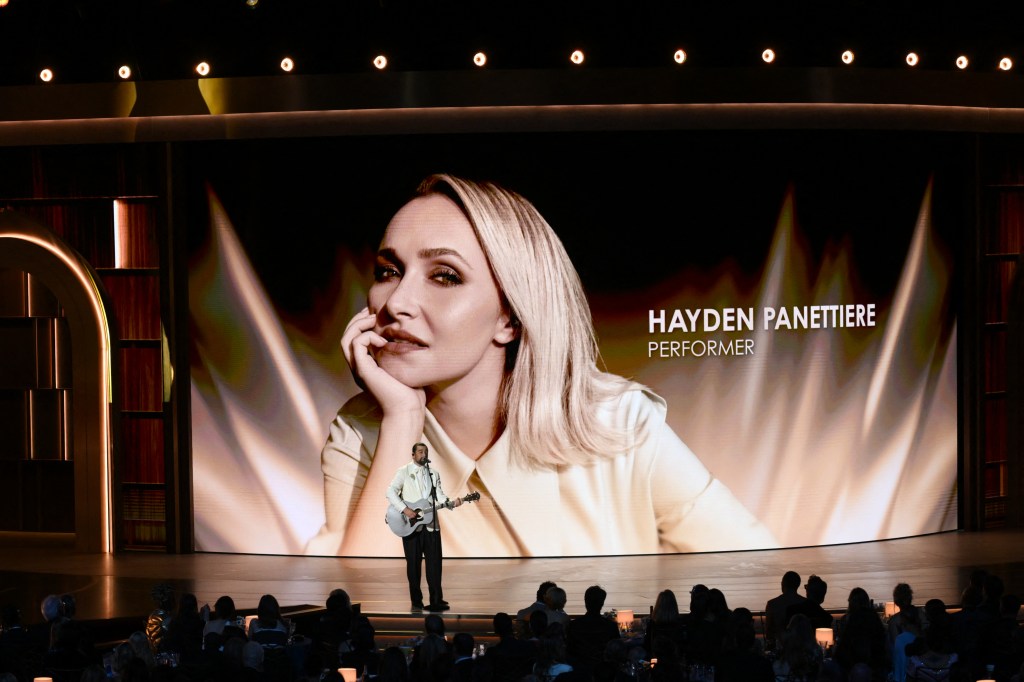 Noah Kahan performs with a picture of Hayden Panettiere projected on screen at the Emmy Awards.