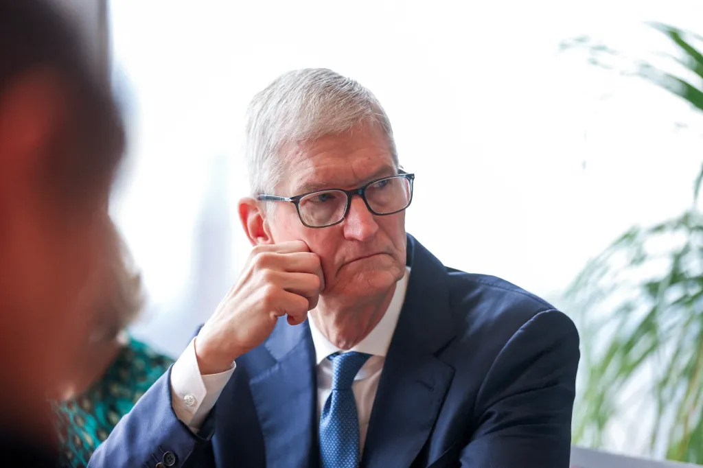 Apple CEO Tim Cook listening during a business and investor roundtable.