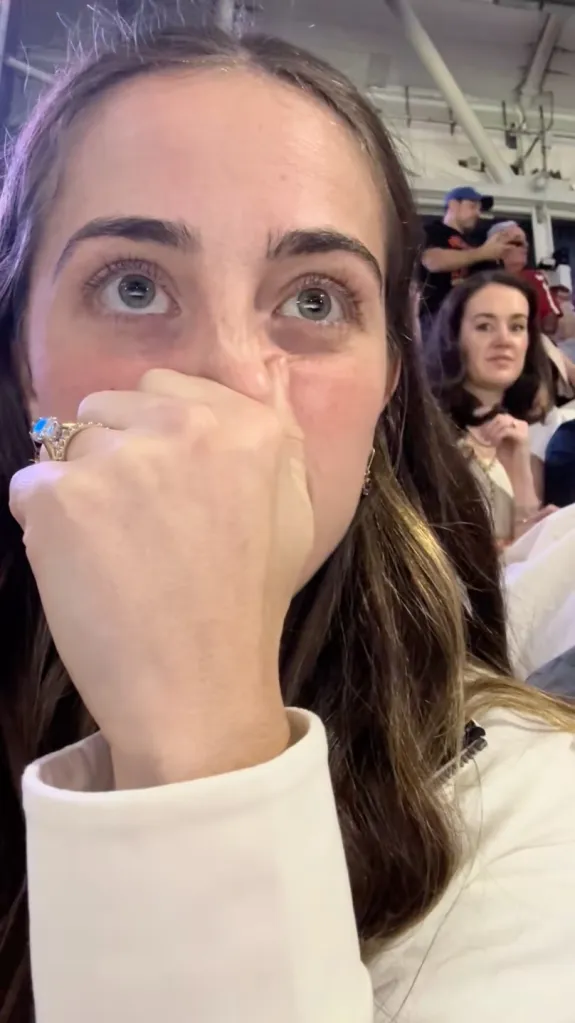 US Open attendee holding her nose. 